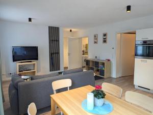 a living room with a couch and a table at Schiller´s Urban Escape in Freudenstadt