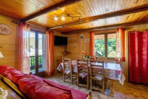 a living room with a couch and a table and chairs at Chalet Lou Murgis in Saint-Sorlin-dʼArves +28 photos