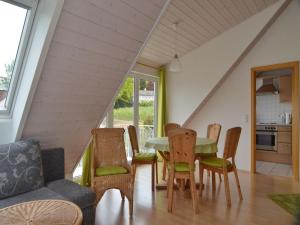 a living room with a table and chairs at Ferienwohnung Ledergerber in Bodman-Ludwigshafen