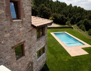 an aerial view of a house with a swimming pool at Torigues in Santa María de Oló