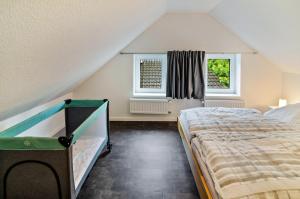 a bedroom with a bed and a window at Seehund in Stedesdorf
