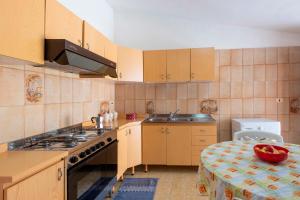 a kitchen with a sink and a stove top oven at Casa Viola - a 100 metri dal mare in Trappeto +22 photos