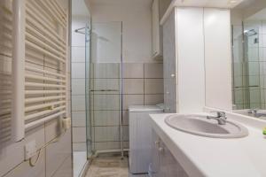 a bathroom with a sink and a glass shower at F1 Massif du Canigou in Vernet-les-Bains +14 photos