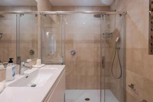 a bathroom with a shower and a sink at Modern Apartment next the Beach in Marbella +25 photos