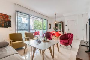 a living room with a table and chairs at Modern Apartment next the Beach in Marbella