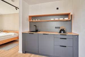 a kitchen with a tea kettle on a counter next to a bed at Alte Seifensiederei - Viktor in Bad Tölz