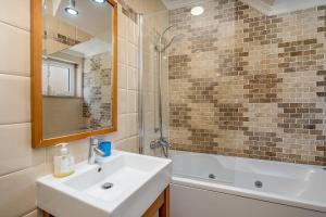 a bathroom with a sink and a bath tub at Beach Apt 1 In Burgau in Burgau +28 photos