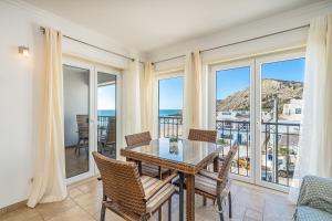 a dining room with views of the ocean at Beach Apt 1 In Burgau in Burgau