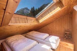 a sauna with two beds in it with a window at Casa Lorenz 3 in Canazei
