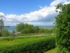 a view of the water from a field at Seeblick Ferienbungalow in Leezen +5 photos