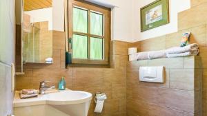 a bathroom with a sink and a toilet and a window at Schwarzwaldliebe in Lenzkirch +13 photos