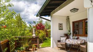 a porch of a house with a table and chairs at Schwarzwaldliebe in Lenzkirch