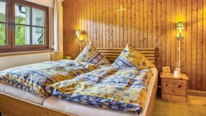 a bed in a room with wooden walls at Schwarzwaldliebe in Lenzkirch