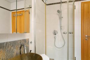a bathroom with a shower and a sink at Christines Ferienwohnung in Eitting +15 photos