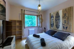 a bedroom with a large bed and a television at Villa Rodolphe in Le Pian-Médoc +37 photos