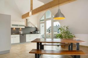 a kitchen with a wooden table and a dining room at Christines Ferienwohnung in Eitting