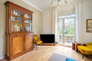 a living room with a large wooden hutch at Maison avec studio Cros de Cagnes in Cagnes-sur-Mer