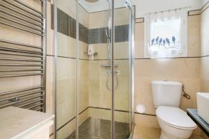 a bathroom with a toilet and a glass shower at Maison avec studio Cros de Cagnes in Cagnes-sur-Mer +21 photos