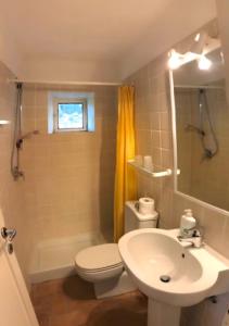 a bathroom with a white toilet and a sink at La Casa Rossa 2 in Bibbona +28 photos
