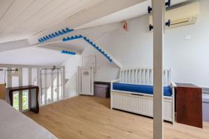 a room with a bed and a staircase in it at Maison avec studio Cros de Cagnes in Cagnes-sur-Mer