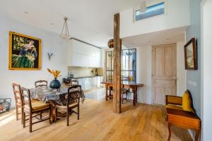 a kitchen and dining room with a table and chairs at Maison avec studio Cros de Cagnes in Cagnes-sur-Mer
