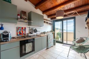 a kitchen with a view of the ocean at Casa Mauro e Roberta Zingaro in Castellammare del Golfo