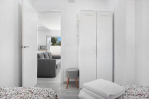a bedroom with two beds and a living room at Villa Soleva in Conil de la Frontera +16 photos
