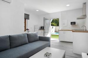 a living room with a couch and a kitchen at Villa Soleva in Conil de la Frontera