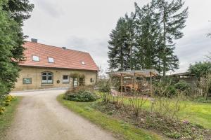 a house with a gravel road in front of it at Alte Schule Pahlkrug in Linden