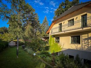 a house with a garden next to a building at The House Stiller Grund in Hohenfließ