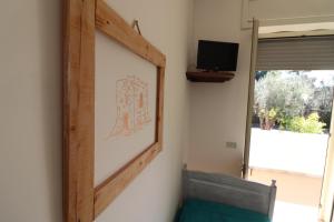 a mirror in a room with a tv on a wall at Casa Vacanza Monte Pulciano Otranto in Otranto
