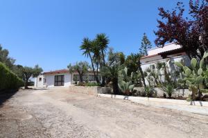 a house with a lot of cactus in front of it at Casa Vacanza Monte Pulciano Otranto in Otranto