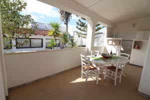 a balcony with a white table and chairs on a patio at Casa Vacanza Monte Pulciano Otranto in Otranto