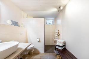 a white bathroom with a sink and a toilet at Ferienwohnung Hennings in Bargenstedt +21 photos