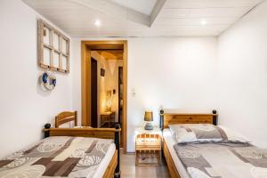 two beds in a bedroom with a table and a chair at Ferienwohnung Hennings in Bargenstedt