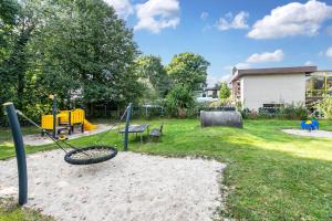 a park with a playground with a swing at Ferienwohnung Hennings in Bargenstedt