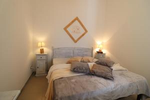 a bedroom with a bed with two night stands and two lamps at Casa Vacanza Monte Pulciano Otranto in Otranto