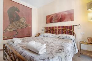 a bedroom with a bed and a painting on the wall at Colorful Apartment in Colico