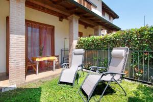 a pair of chairs and a table on a yard at Colorful Apartment in Colico