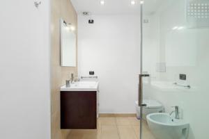 a bathroom with a sink and a toilet and a mirror at Villa Marconi Apartment 9 in Golfo Aranci +19 photos