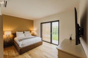a bedroom with a bed and a large window at Luxe Villa Maxime in Lazise