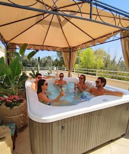 a group of people sitting in a bath tub at Salento Houses & Idro Suites in Nardò