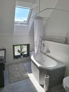 a white bathroom with a tub and a sink at Zillestuben Altenburg in Altenburg
