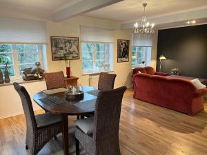 a living room with a table and chairs and a couch at Apartment an der Liitard Kull in Neukirchen-Vluyn
