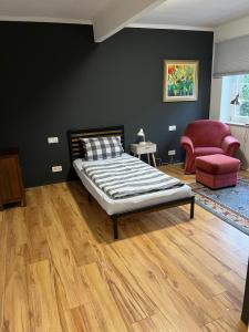 a bedroom with a bed and a couch and a chair at Apartment an der Liitard Kull in Neukirchen-Vluyn