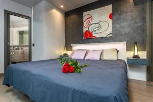 a bedroom with a blue bed with roses on it at Tao Rama Suite in Taormina