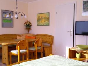 a kitchen and dining room with a table and chairs at Lotte und Helmut Klanner in Daisendorf +5 photos