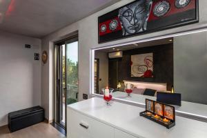 a room with a mirror and a table with wine glasses at Tao Rama Suite in Taormina +22 photos