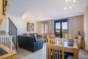 a living room with a couch and a table at Duplex apartment Estepona in Estepona
