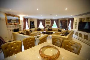 a large living room with couches and a table at Ballagh House in Navan
